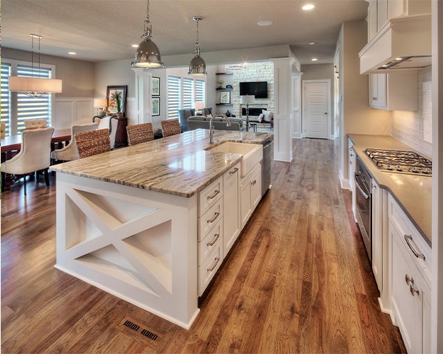 Kitchen with center island and white cabinets in the Ashberry model