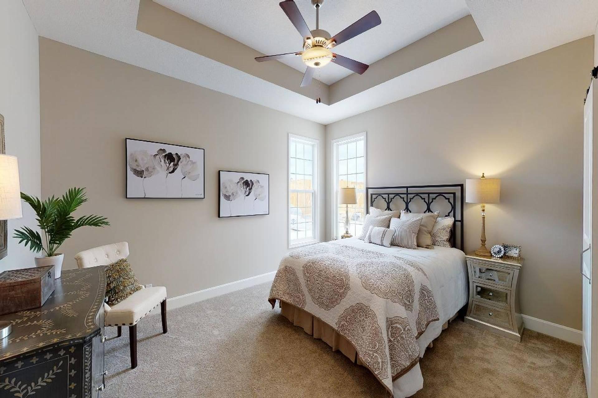 bedroom with large bed in a Todd model from Lambie custom homes