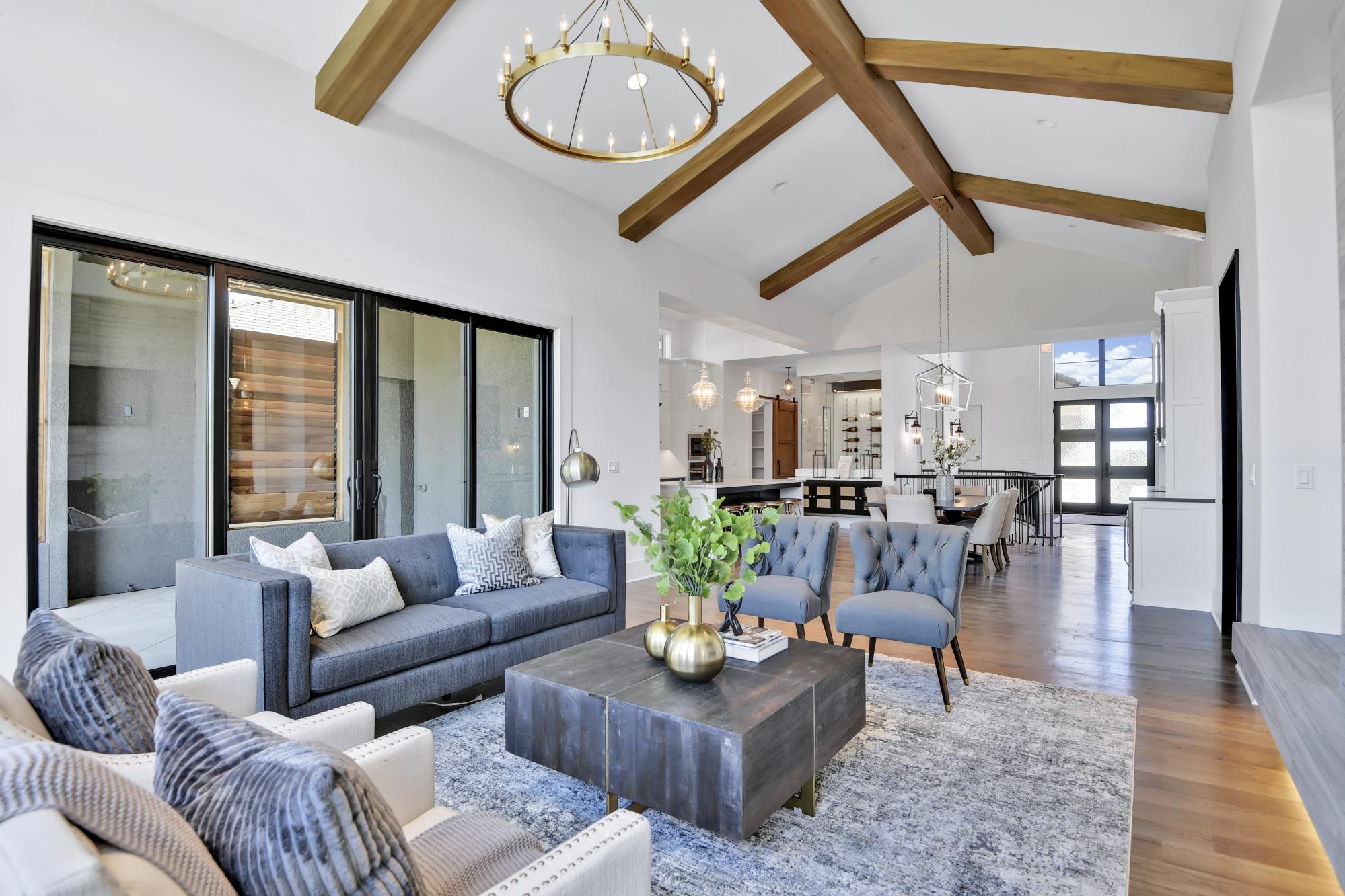 Living room with lots of seating in an Oakmont model from Lambie Custom Homes