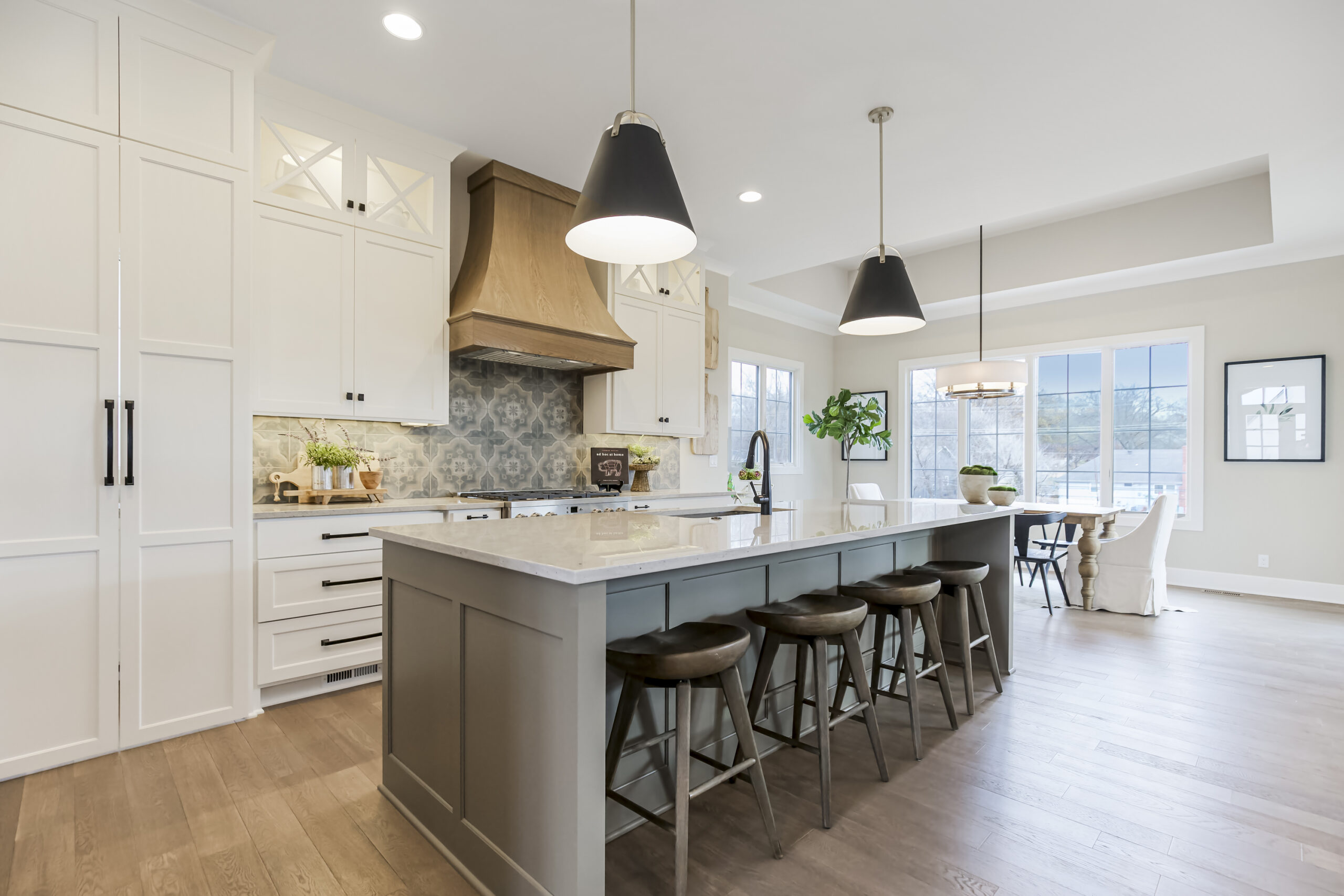 Kitchen with center island and white cabinets in a regents park home from Lambie homes