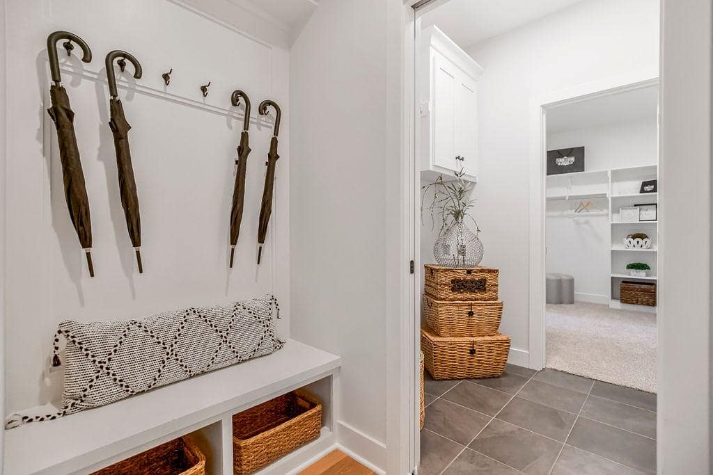 Mud room with built in bench and hangers in a large lambie custom home