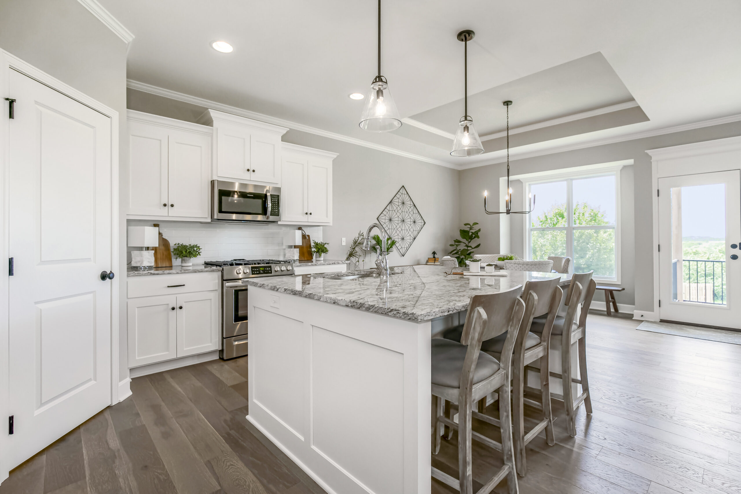 Kitchen with white cabinets and center island from lambie homes