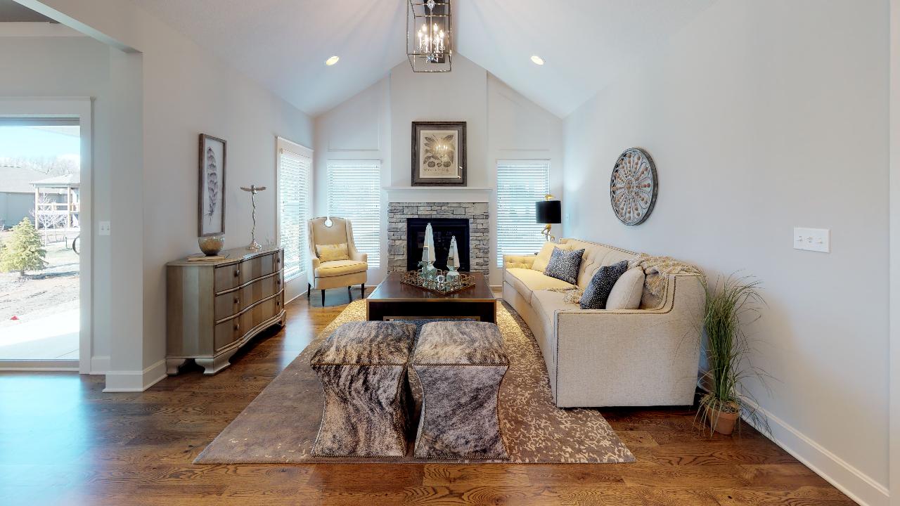 Living room with stone fireplace in the cottonwood model from lambie homes