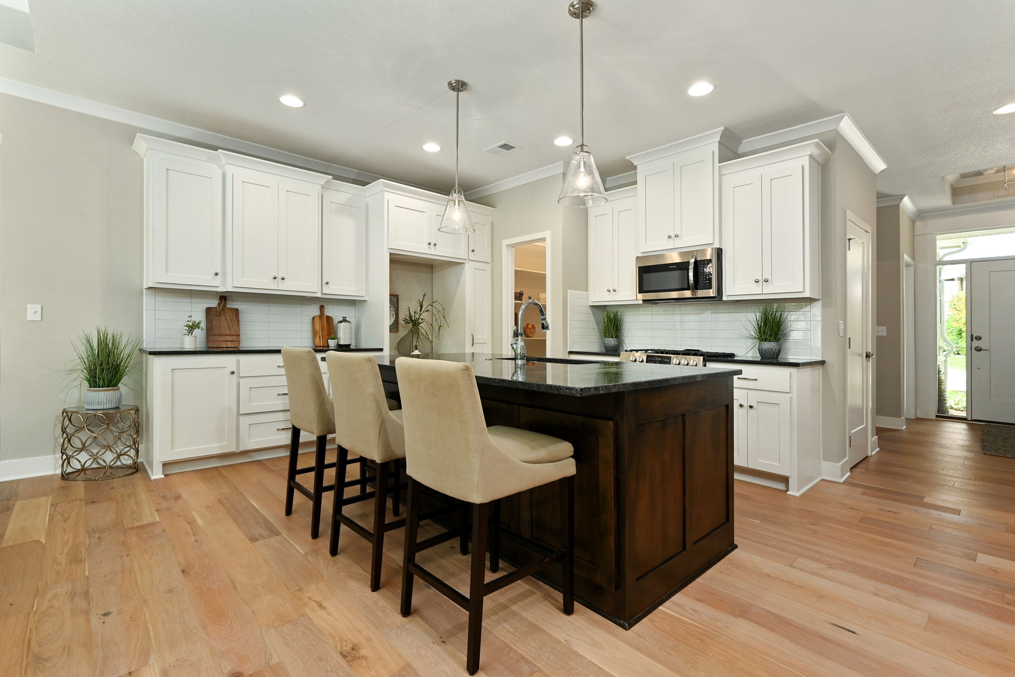 Kitchen with white cabinets and center island in 16221 Broadmoor St., Overland Park, KS