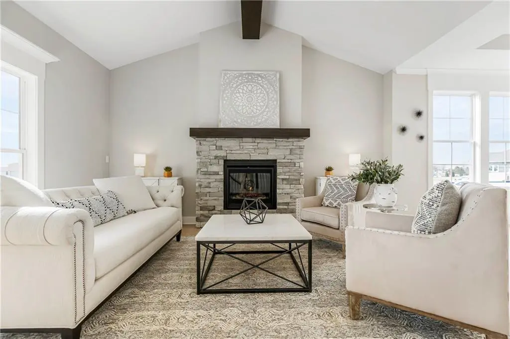 Living room with stone fireplace in 21922 W 82nd Ter from Lambie Homes